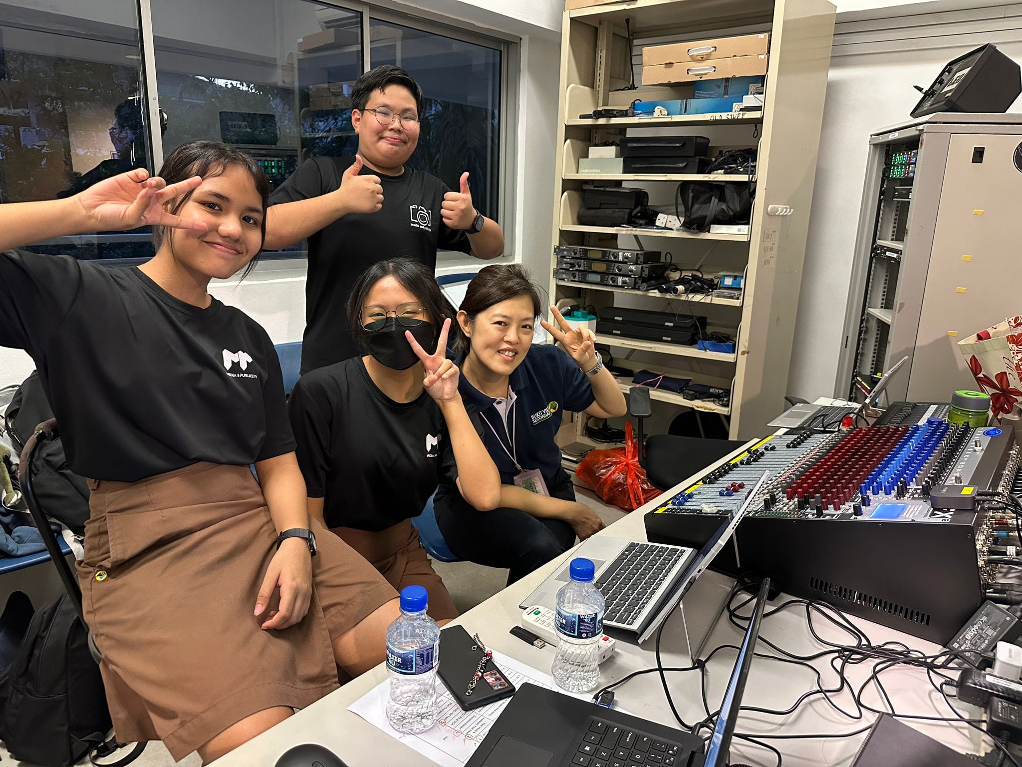 Media & Publicity CCA members operating audio equipment while supporting a school event.